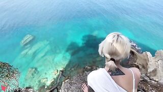 A young girl passionately sucks cock on the ocean shore