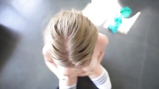 A sweet girl is having fun with her coach in the gym