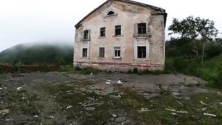 An exhibitionist girl walks through abandoned buildings in a daring act