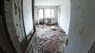 An exhibitionist girl walks through abandoned buildings in a daring act