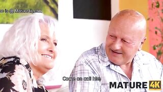 A mature woman seduces a guy while her husband watches