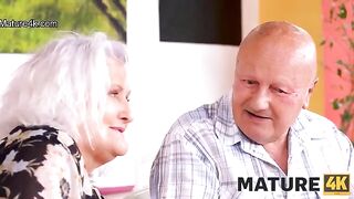 A mature woman seduces a guy while her husband watches