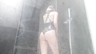 A hot woman plays with her pussy in the shower and squirts