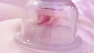A girl plays with her nipples and clitoris using a toy