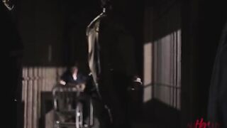 Two girls are having fun behind the bars of a prison