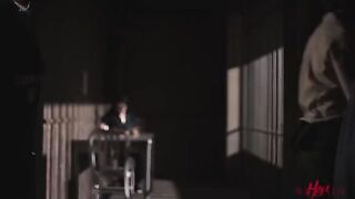 Two girls are having fun behind the bars of a prison