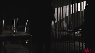 Two girls are having fun behind the bars of a prison