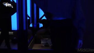 A girl is trying on clothes in the fitting room, as a curious guy peeps in