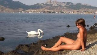Nudist beauties have fun on the river bank