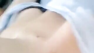 A half-naked girl lies and strokes her body with her hands in a sensual way