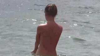 A group of people is fucking on the beach without any clothes