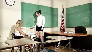 A girl is having fun with her teacher at her desk