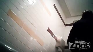The camera is secretly filming a woman in the toilet