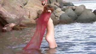 A sexy girl has small boobs and takes off her clothes in the forest
