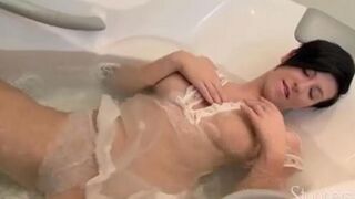 Brunette enjoys solo sex in the shower stream