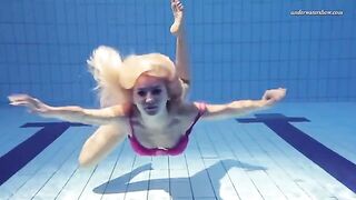 Nude beauty swimming in the pool is very exciting