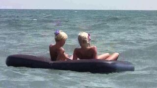 A naked girl is having fun on the beach with her boyfriend