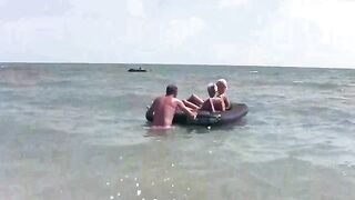 A naked girl is having fun on the beach with her boyfriend