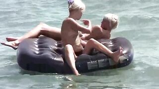 A naked girl is having fun on the beach with her boyfriend