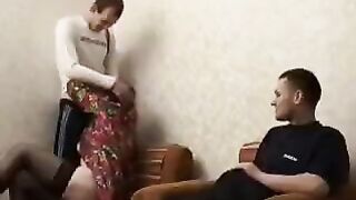 A mature woman fucks her son's friend in the ass