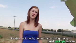 A red-haired girl is fucking on the hay in the yard