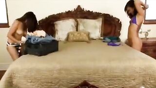 An Asian girl is fucking with her girlfriend on a bed