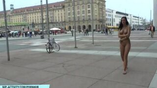 Nude chick is walking the city streets