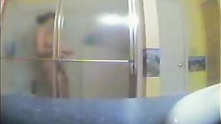 A girl has no idea that someone is watching her showering in the bath