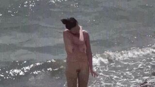 A couple of free-spirited nudists enjoy their beach day