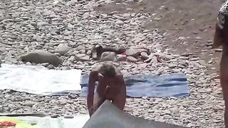 A couple of free-spirited nudists enjoy their beach day
