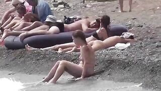 A couple of free-spirited nudists enjoy their beach day