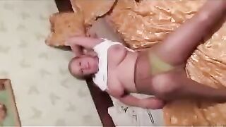A pregnant woman is leaking milk in front of the photographer