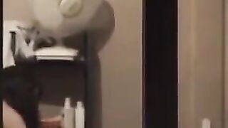 The guy admires himself in the mirror, completely naked