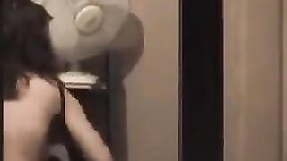 The guy admires himself in the mirror, completely naked
