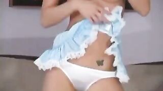 An incredibly cute young girl with a perfect body shows her tits
