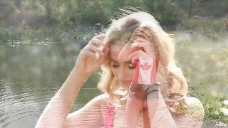 A sexy blonde has a tender solo moment on the lake shore