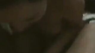 A fat woman is dancing on the bed in front of her husband