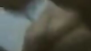 A fat woman is dancing on the bed in front of her husband