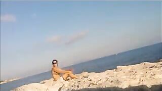 A young girl sunbathes naked on the beach. It's not every day to see that