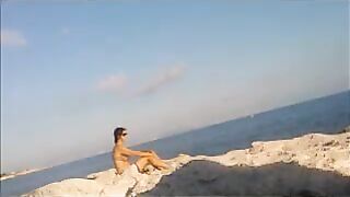 A young girl sunbathes naked on the beach. It's not every day to see that
