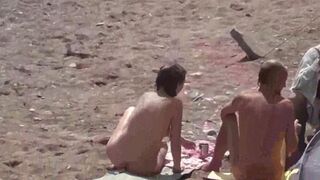A group of naked girls are having fun in the sea