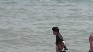 A group of naked girls are having fun in the sea
