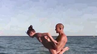Nude acrobatic sex on the beautiful beach