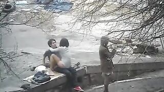 A young couple engaged in public sex on the street, captured in a daring shot