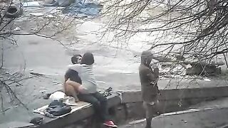 A young couple engaged in public sex on the street, captured in a daring shot