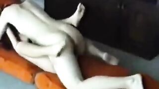 A young married couple engaged in passionate sex at their home