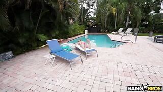 A girl is having fun in the swimming pool with a man