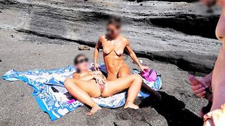 A girl undresses on the beach and rubs herself, while a guy masturbates