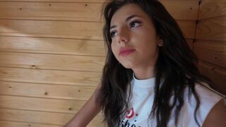 A stunning brunette gets ready to shed her clothes and embrace intimacy in the sauna