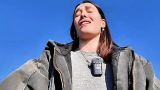 A hot brunette gets naughty on the beach in a daring vlog
